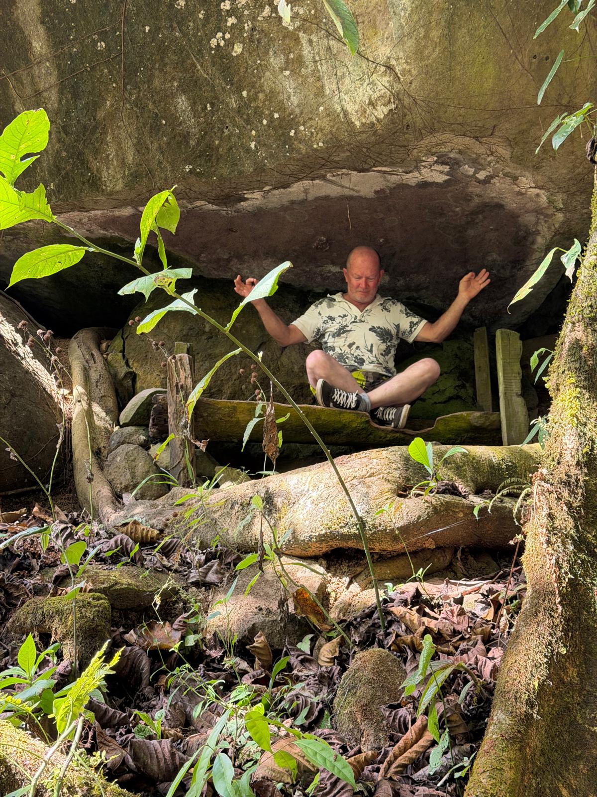 Meditation nook beneath a stone overhang at Hacienda La Cascada